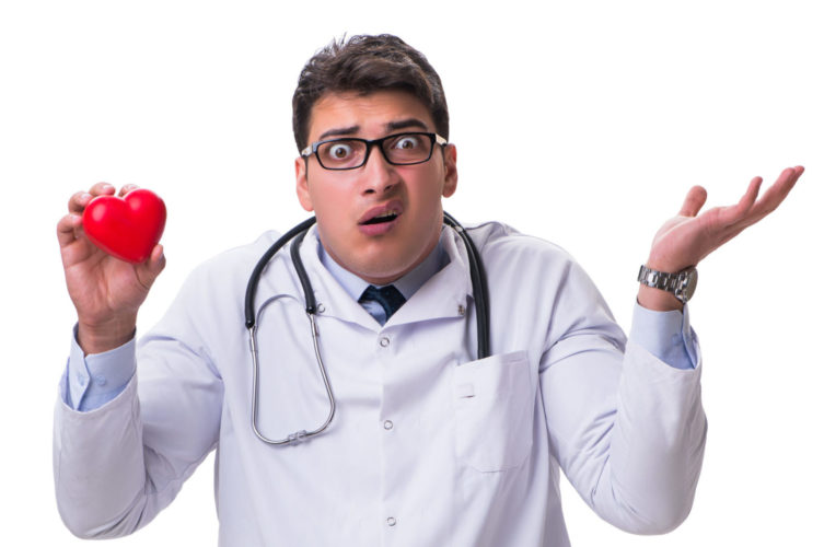 Young Male Cardiologist Doctor Holding A Heart Isolated On White